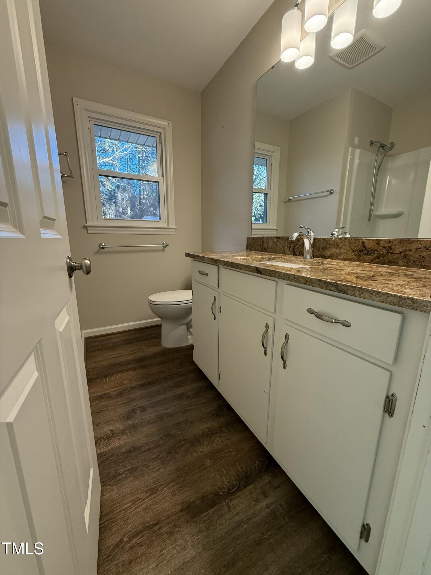 640 Crocker Road Smithfield, NC 27577 - Photo 14 of 28 a bathroom with a granite countertop sink mirror vanity and toilet