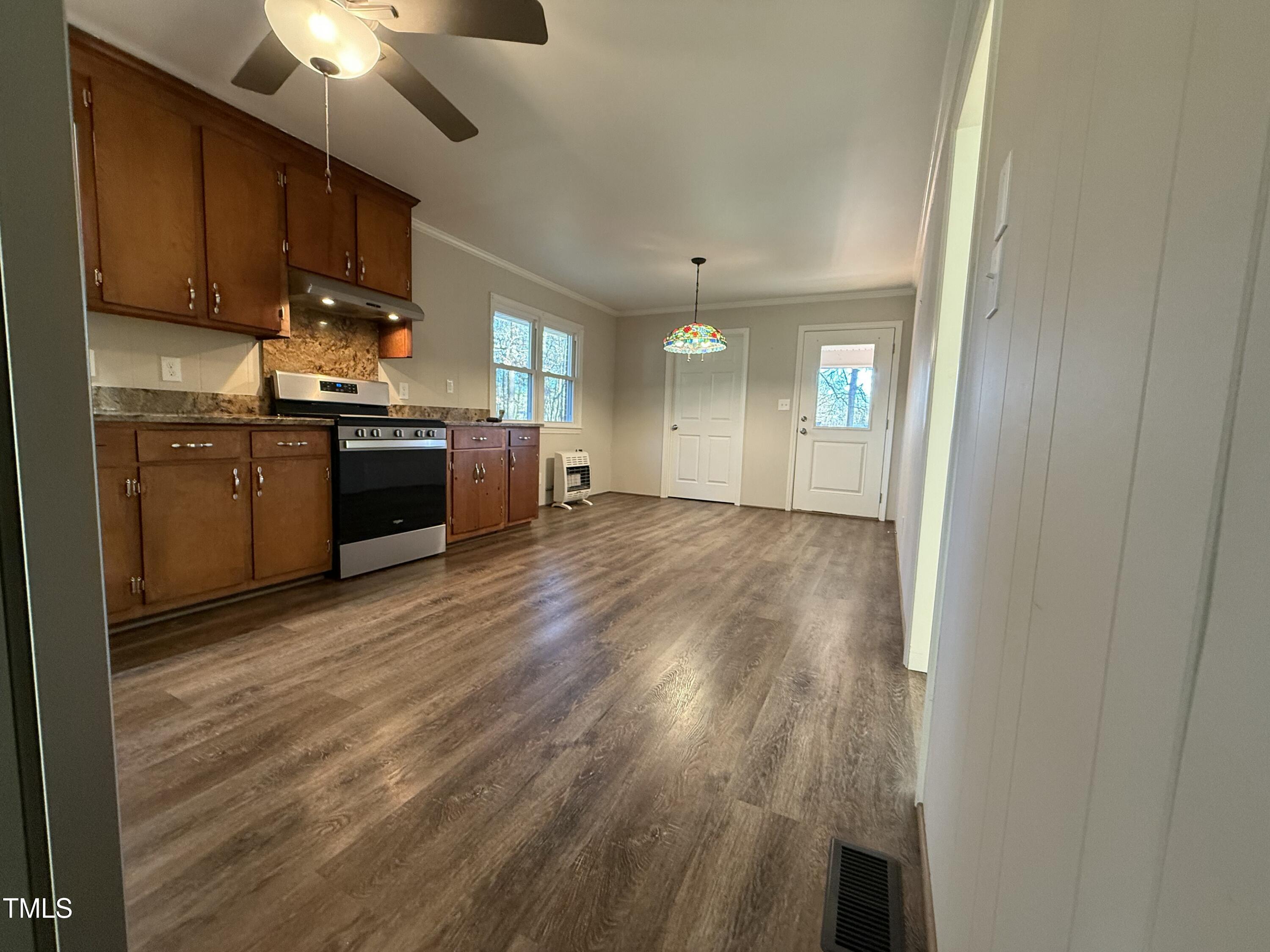 640 Crocker Road Smithfield, NC 27577 - Photo 19 of 28 a kitchen with granite countertop a stove top oven a sink dishwasher and a refrigerator with wooden floor