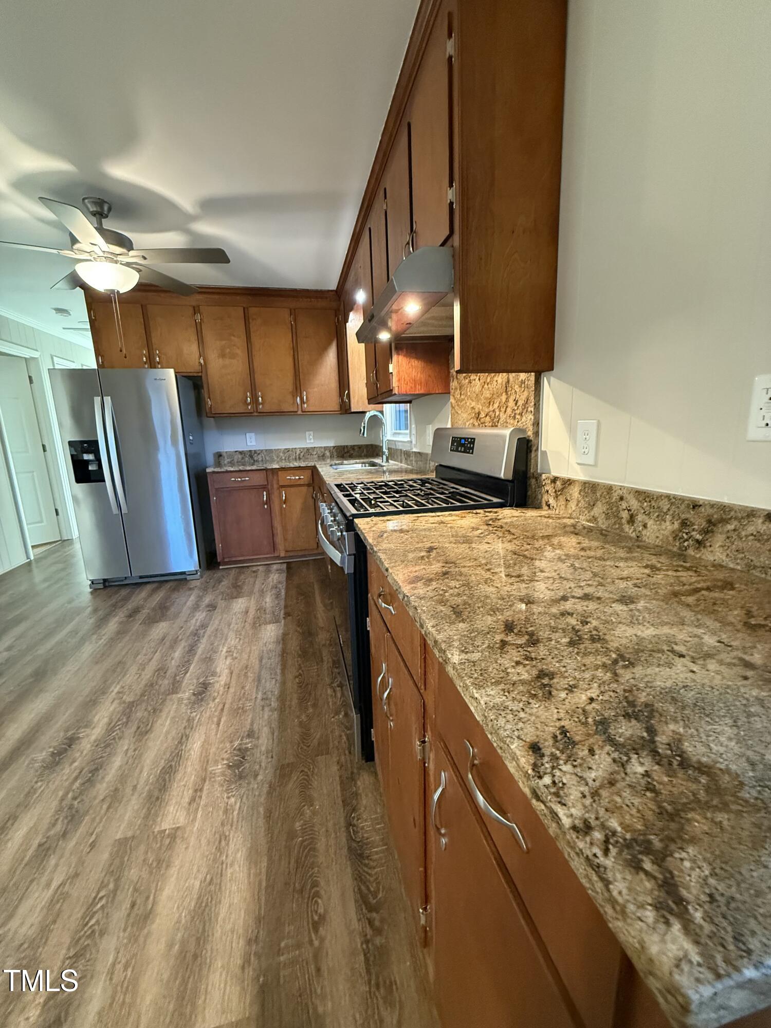 640 Crocker Road Smithfield, NC 27577 - Photo 21 of 28 a kitchen with a stove and a wooden floors