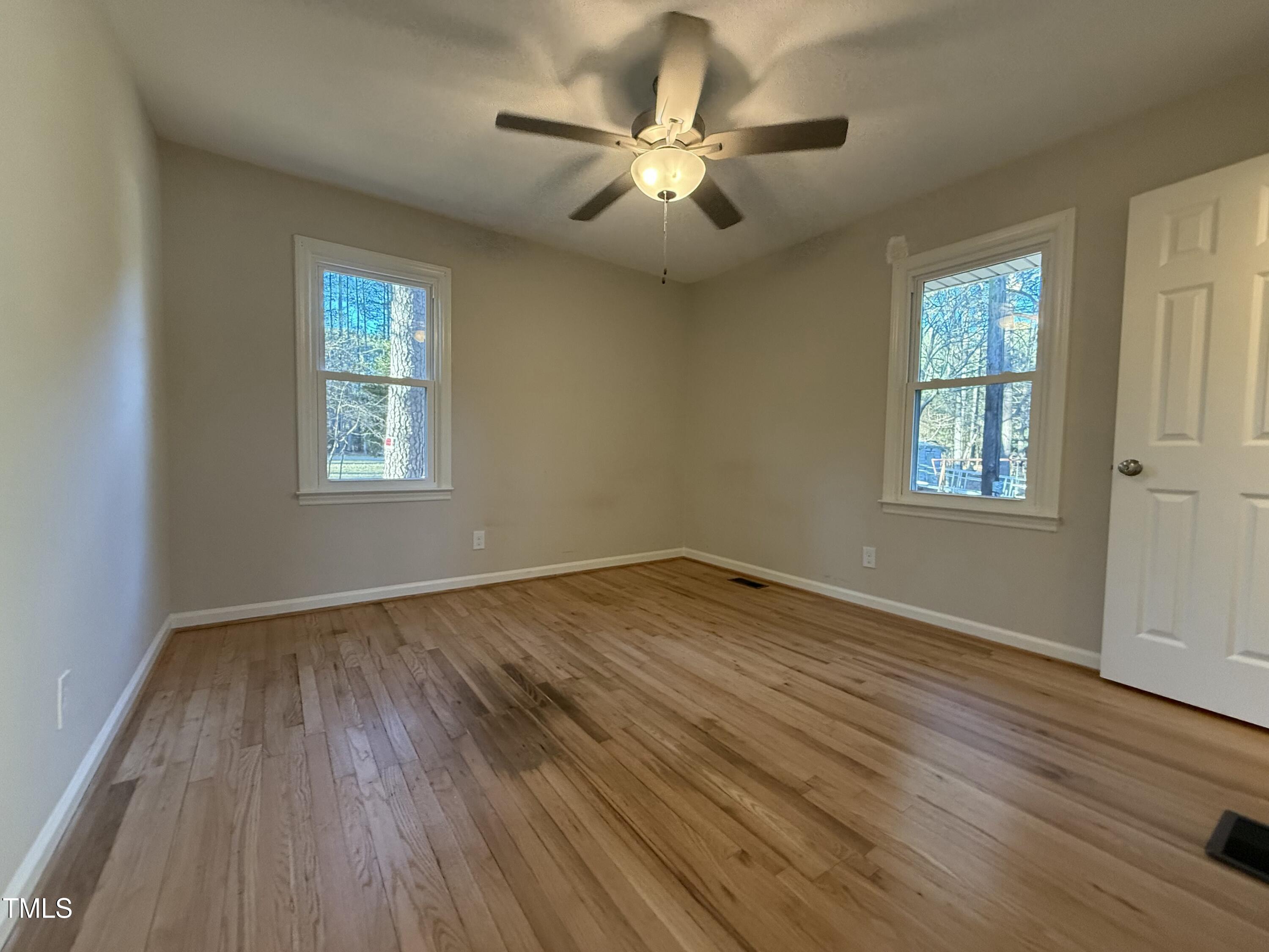 640 Crocker Road Smithfield, NC 27577 - Photo 8 of 28 wooden floor in an empty room with a window
