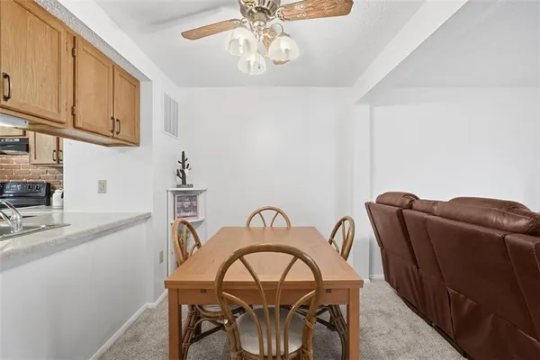 a view of a dining room with furniture and chandelier