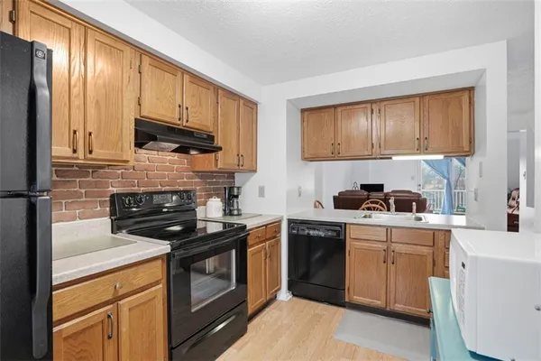 a kitchen with stainless steel appliances granite countertop a stove a sink dishwasher and a refrigerator
