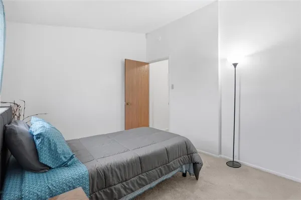 a bedroom with a bed and a couch