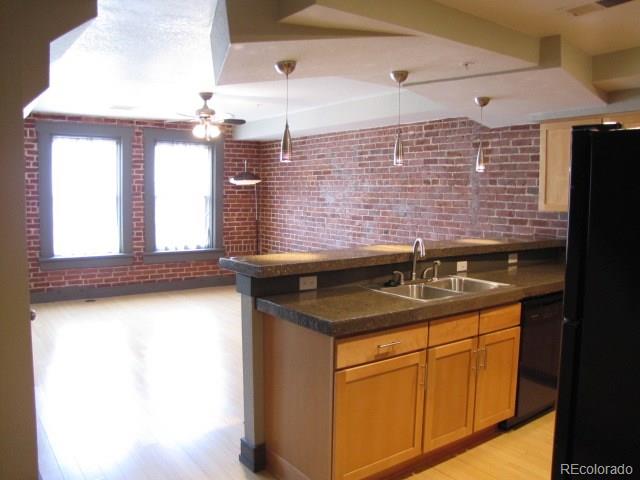232 Broadway, Unit 2 Denver, CO 80203 - Photo 1 of 12 a kitchen with a sink and a refrigerator