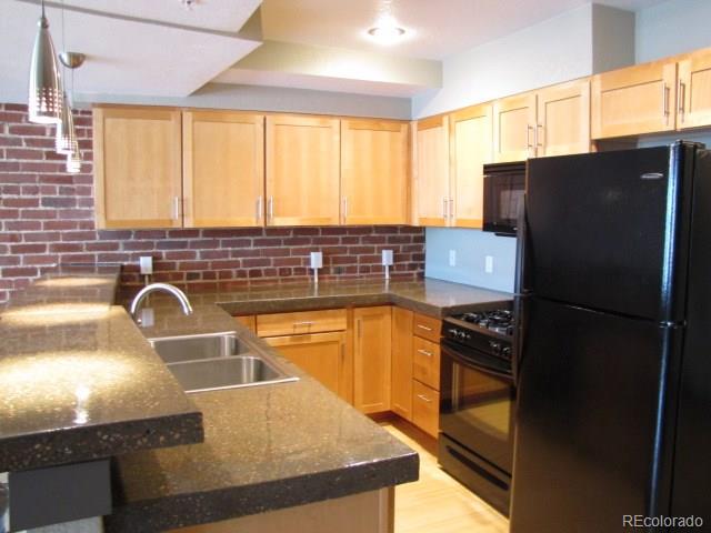 232 Broadway, Unit 2 Denver, CO 80203 - Photo 2 of 12 a kitchen with granite countertop a refrigerator and a sink