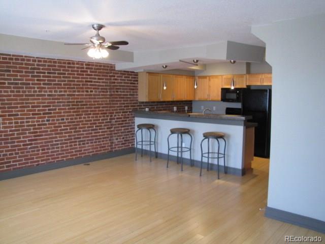 232 Broadway, Unit 2 Denver, CO 80203 - Photo 3 of 12 a kitchen with stainless steel appliances a sink stove and refrigerator