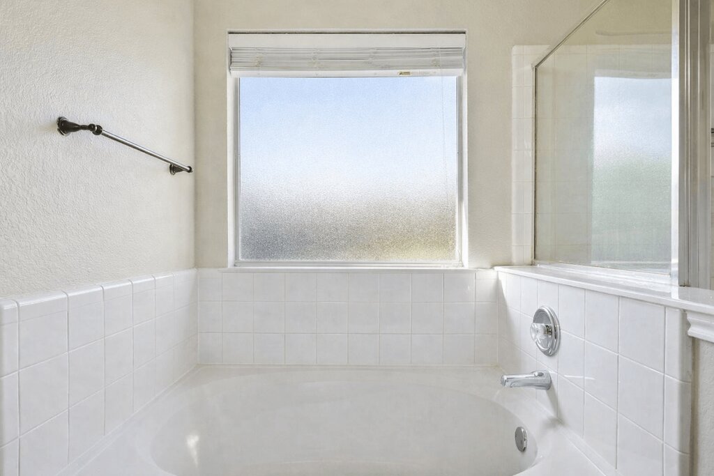 1201 Ridgewood Drive Leander, TX 78641 - Photo 19 of 29 Full bath featuring a bath and a textured wall