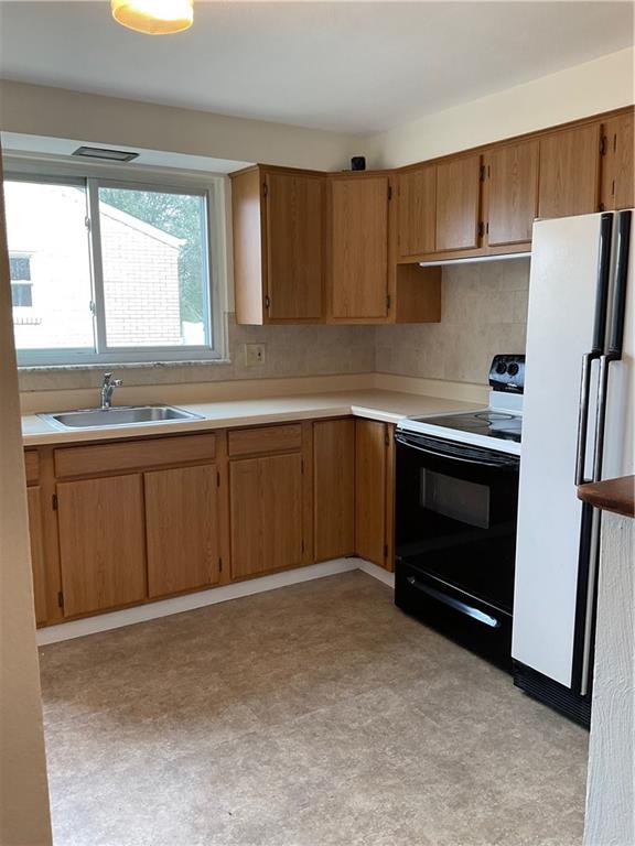 115 Starling Drive McKees Rocks, PA 15136 - Photo 5 of 12 a kitchen with a sink and a refrigerator