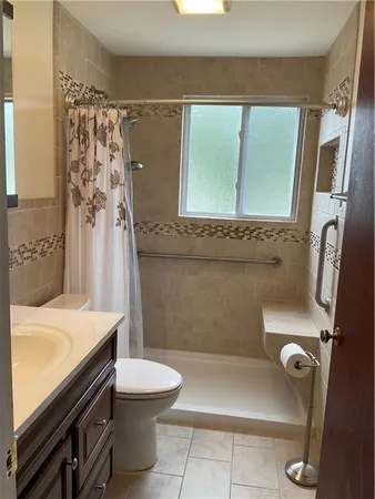 a bathroom with a sink a toilet and a shower