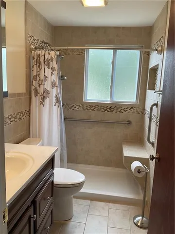 a bathroom with a sink a toilet and a shower