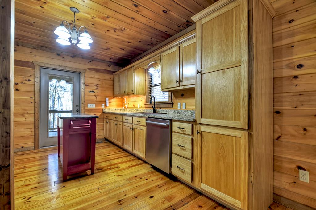 99 Cedar Ridge Road Cherry Log, GA 30522 - Photo 12 of 56 a kitchen with stainless steel appliances granite countertop a refrigerator a sink dishwasher a stove and a dining table with wooden floor