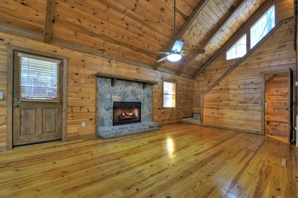 99 Cedar Ridge Road Cherry Log, GA 30522 - Photo 6 of 56 a view of an empty room with wooden floor fireplace and a window