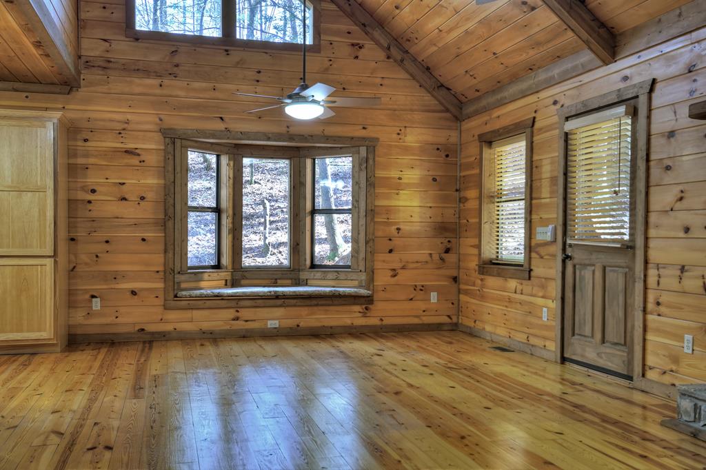 99 Cedar Ridge Road Cherry Log, GA 30522 - Photo 8 of 56 an empty room with wooden floor and windows