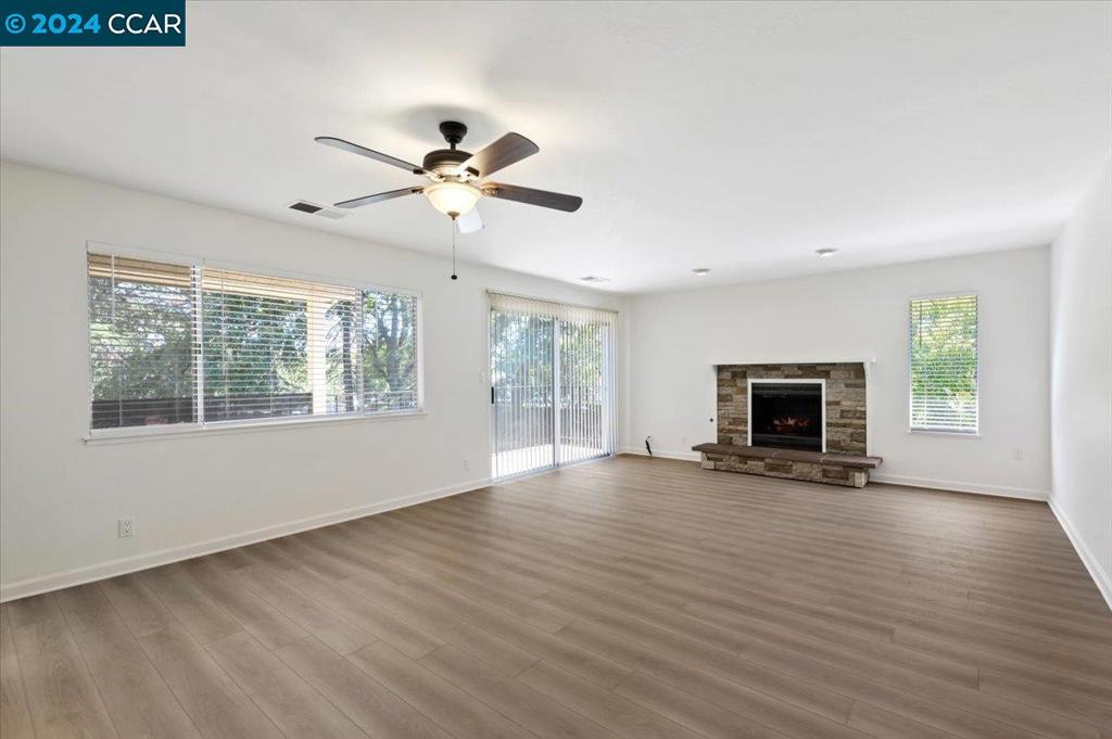 1050 Wesley Court Walnut Creek, CA 94597 - Photo 13 of 32 a view of empty room with wooden floor and fireplace