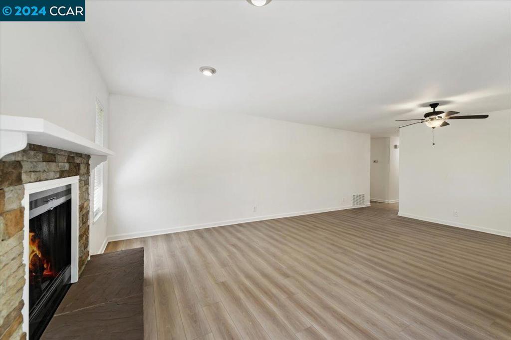 1050 Wesley Court Walnut Creek, CA 94597 - Photo 15 of 32 wooden floor in an empty room with a fireplace
