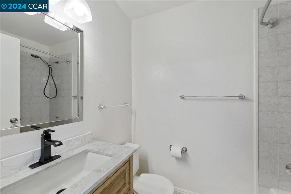 1050 Wesley Court Walnut Creek, CA 94597 - Photo 24 of 32 a bathroom with a sink vanity granite and toilet