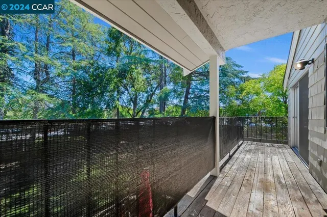 a view of a balcony with wooden floor