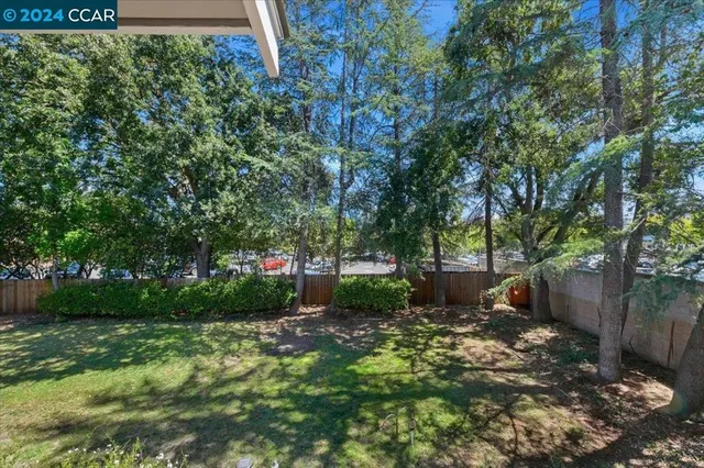 a large kitchen with a large window and stainless steel appliances
