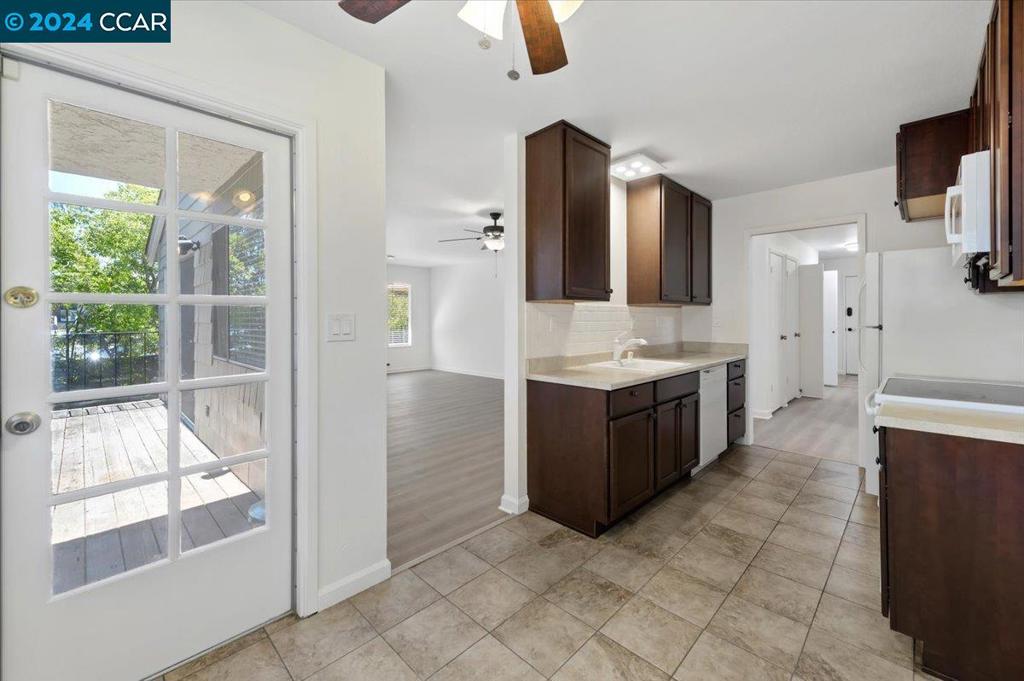 1050 Wesley Court Walnut Creek, CA 94597 - Photo 6 of 32 a large kitchen with a large window and stainless steel appliances