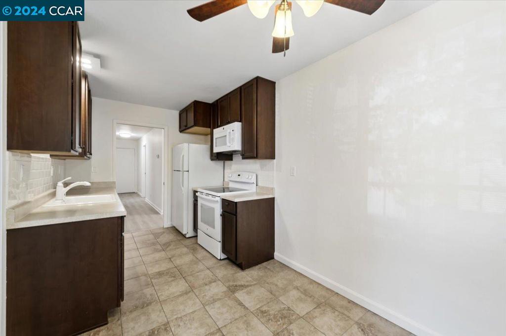 1050 Wesley Court Walnut Creek, CA 94597 - Photo 7 of 32 a bathroom with a sink a vanity and mirror
