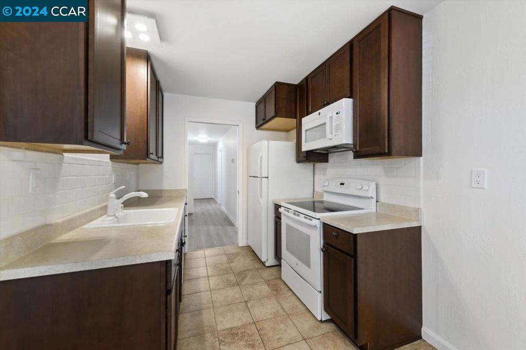 1050 Wesley Court Walnut Creek, CA 94597 - Photo 10 of 32 a kitchen with a sink stove and refrigerator