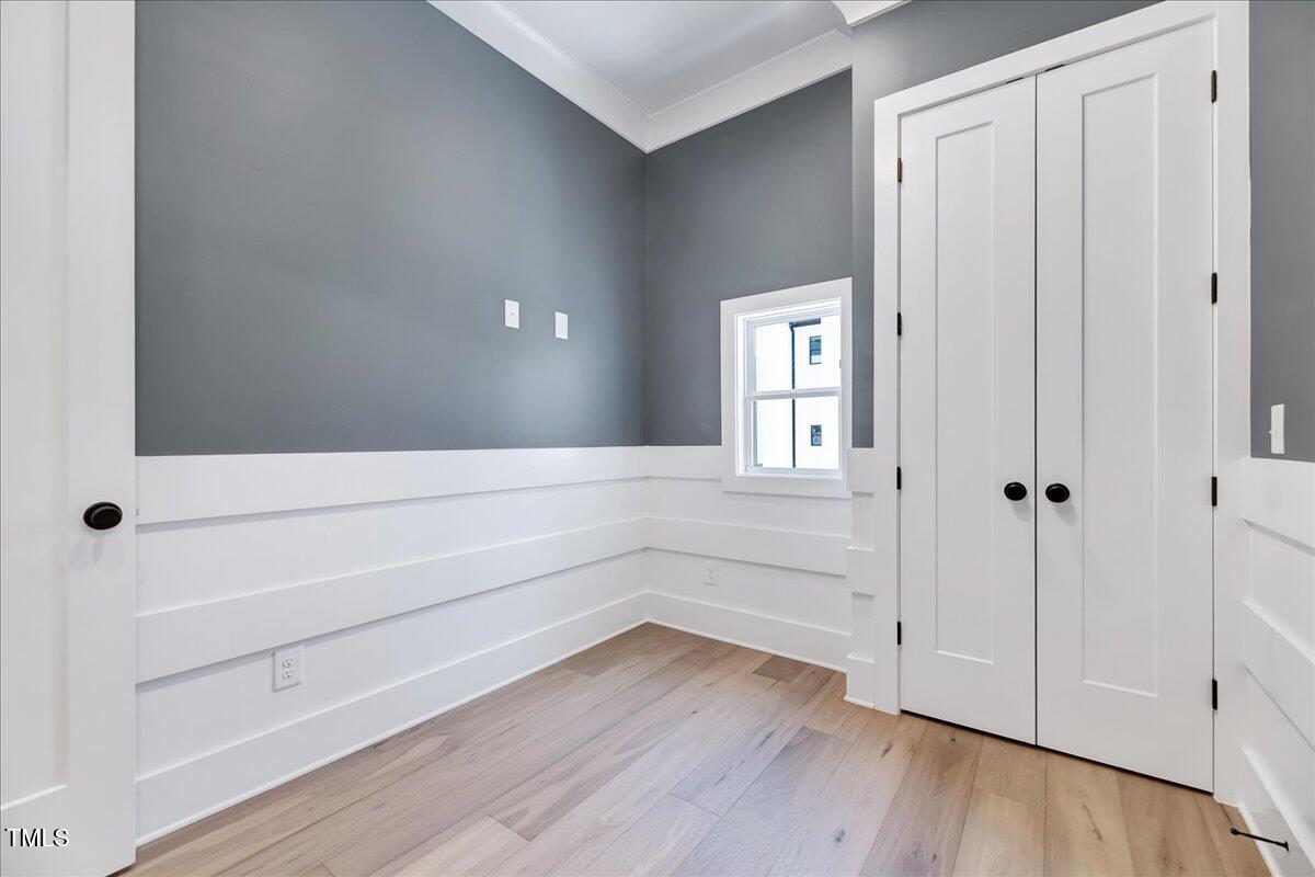 811 Maple Berry Lane, Unit 106 Raleigh, NC 27607 - Photo 10 of 30 a view of an empty room and wooden floor