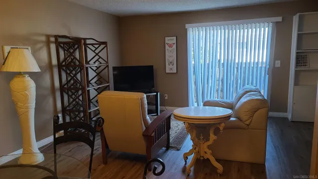 a dining room with furniture and wooden floor