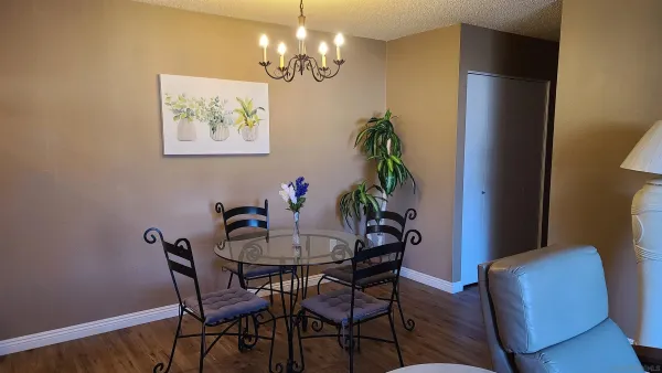 a view of a dining room with furniture and chandelier