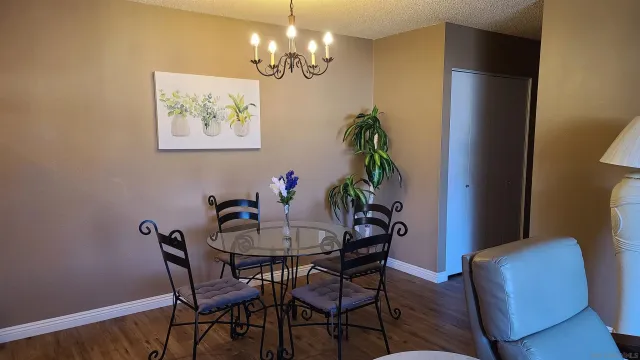 a view of a dining room with furniture and chandelier