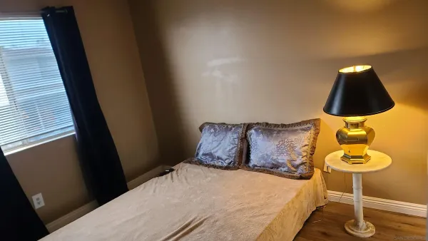 a bed sitting in a bedroom next to a window