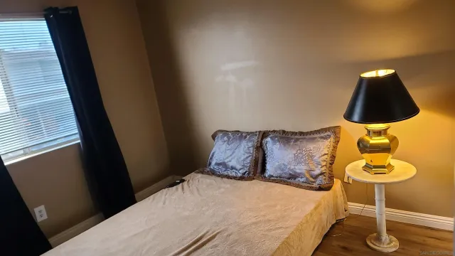 a bed sitting in a bedroom next to a window