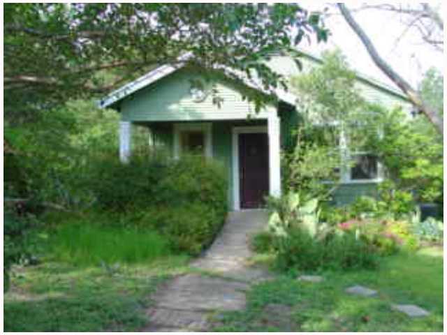 5002 Baker Street Austin, TX 78721 - Photo 1 of 1 a front view of a house with a yard and trees