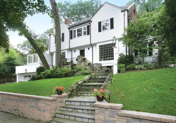 110 Arlington Road Brookline, MA 02467 - Photo 1 of 12 a front view of a house with a yard and potted plants