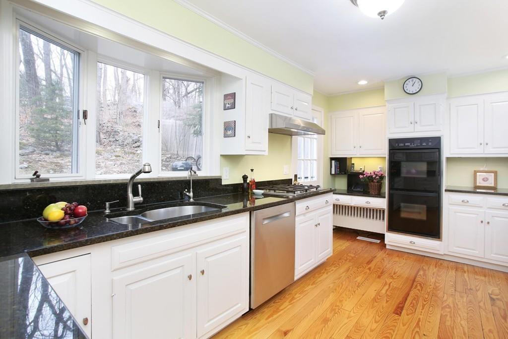 110 Arlington Road Brookline, MA 02467 - Photo 7 of 12 a kitchen with granite countertop a sink cabinets and window