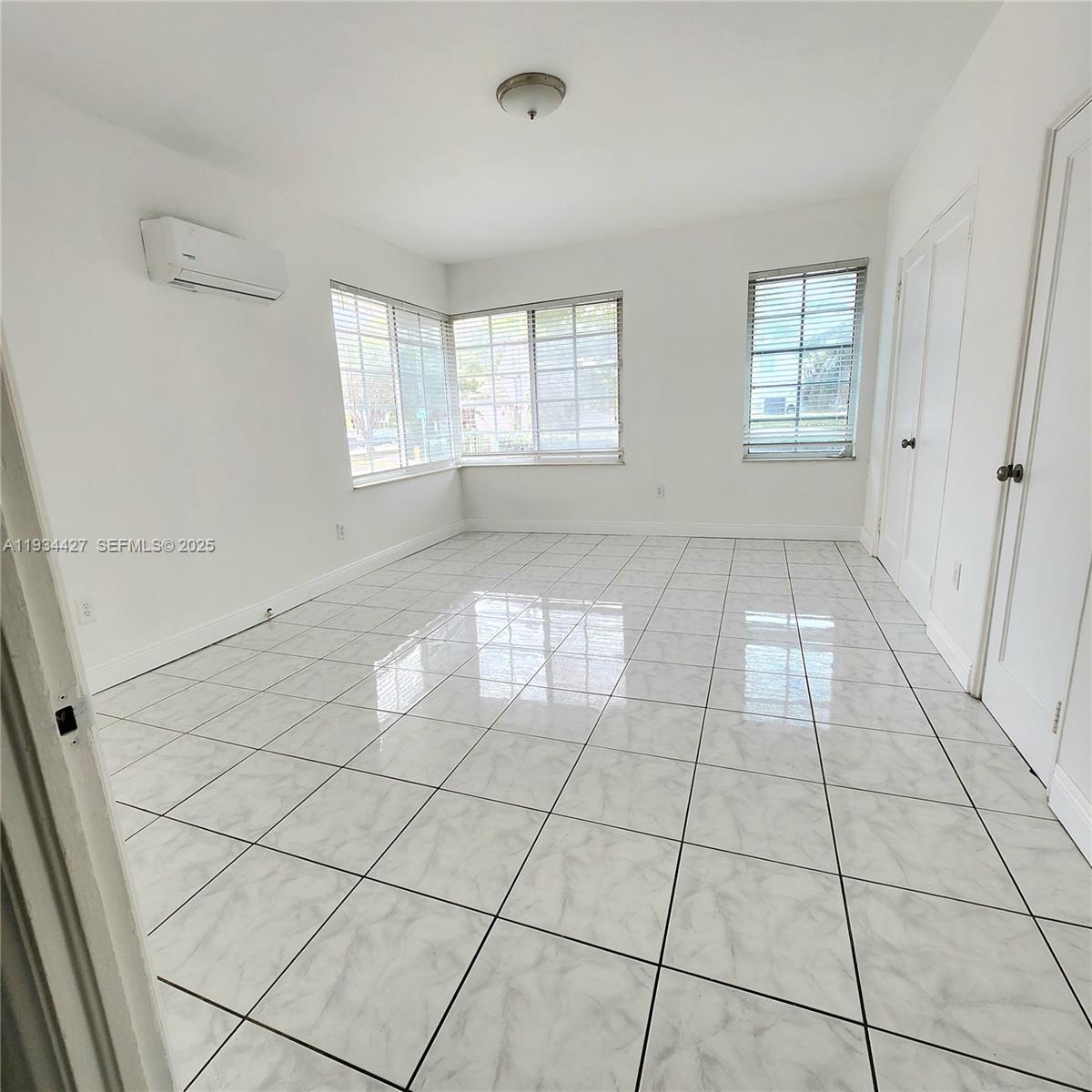 7936 Harding Avenue, Unit 4 Miami Beach, FL 33141 - Photo 12 of 12 a view of an empty room and window