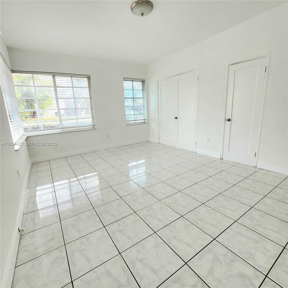 7936 Harding Avenue, Unit 4 Miami Beach, FL 33141 - Photo 9 of 12 a view of an empty room and window