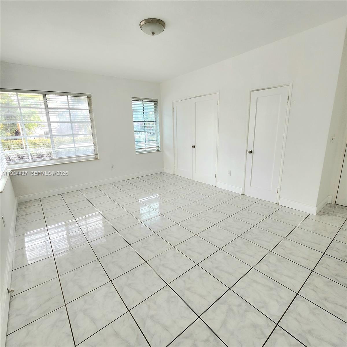 7936 Harding Avenue, Unit 4 Miami Beach, FL 33141 - Photo 10 of 12 an empty room with windows