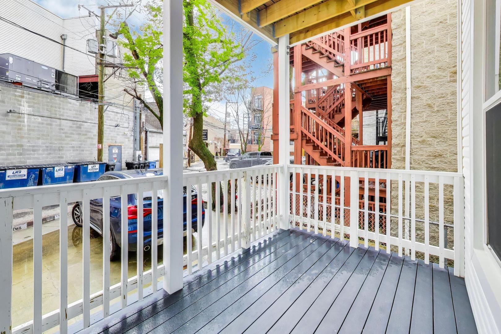 3519 North Seminary Avenue Chicago, IL 60657 - Photo 11 of 43 a view of balcony with wooden floor and fence and a floor to ceiling window