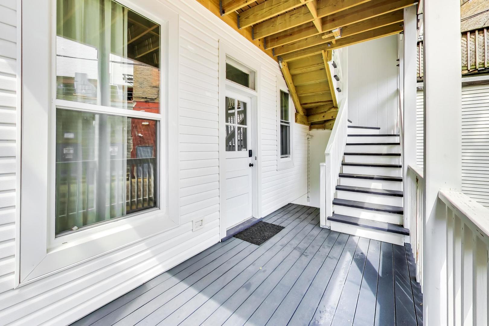 3519 North Seminary Avenue Chicago, IL 60657 - Photo 12 of 43 a view of a balcony with wooden floor and fence