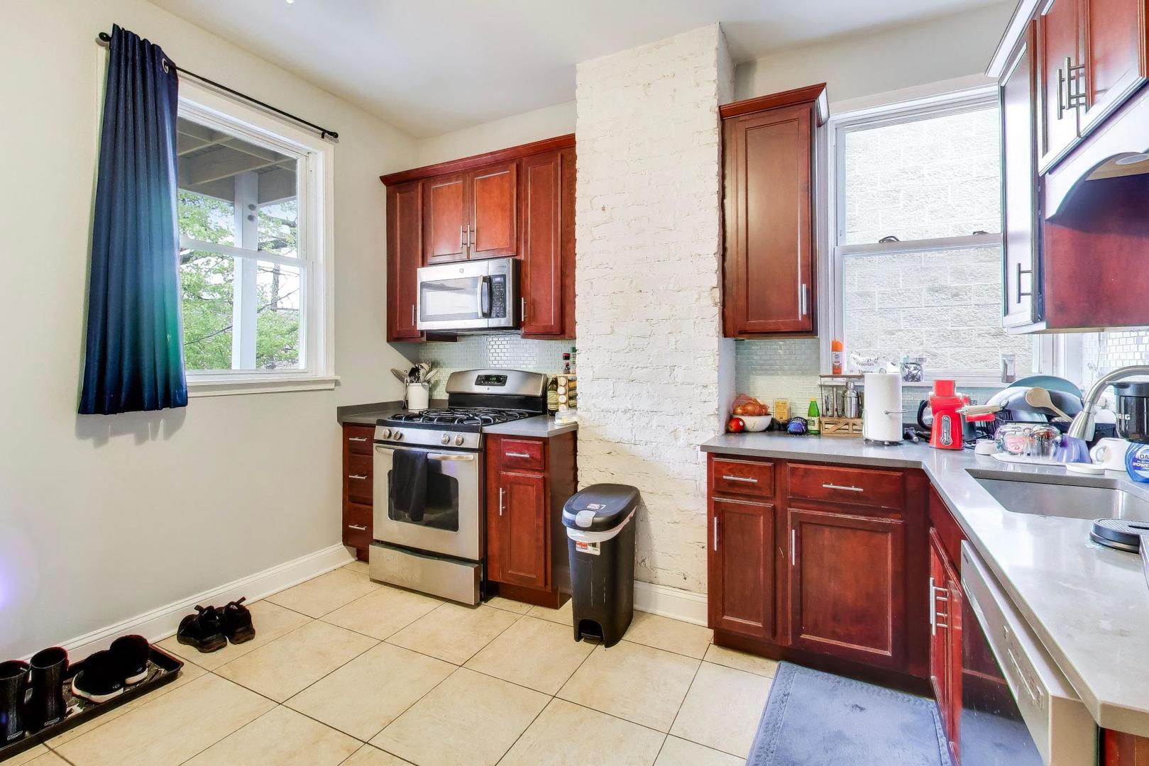 3519 North Seminary Avenue Chicago, IL 60657 - Photo 17 of 43 a kitchen with stainless steel appliances a stove a sink and a microwave