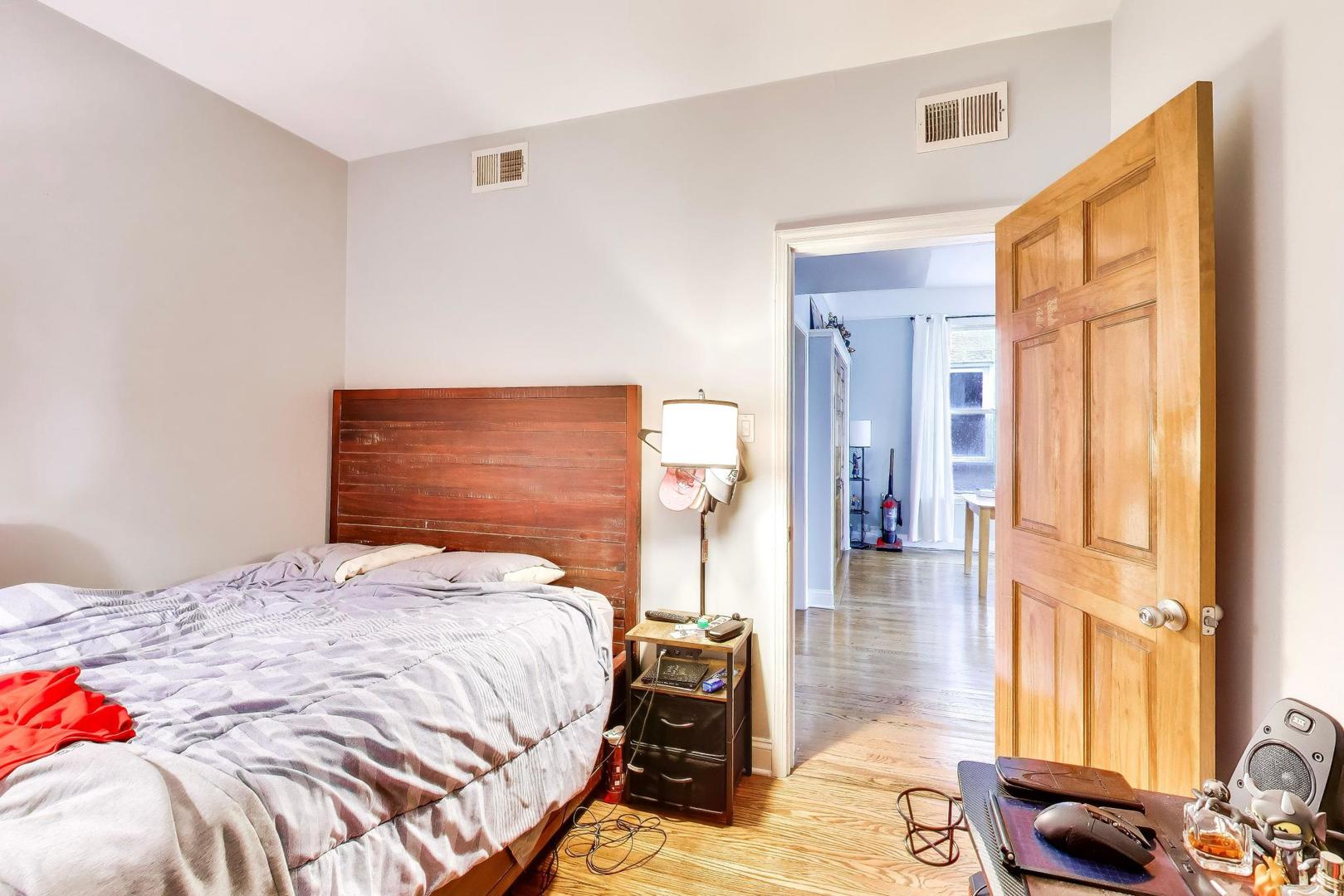 3519 North Seminary Avenue Chicago, IL 60657 - Photo 19 of 43 a bedroom with a bed and wooden floor