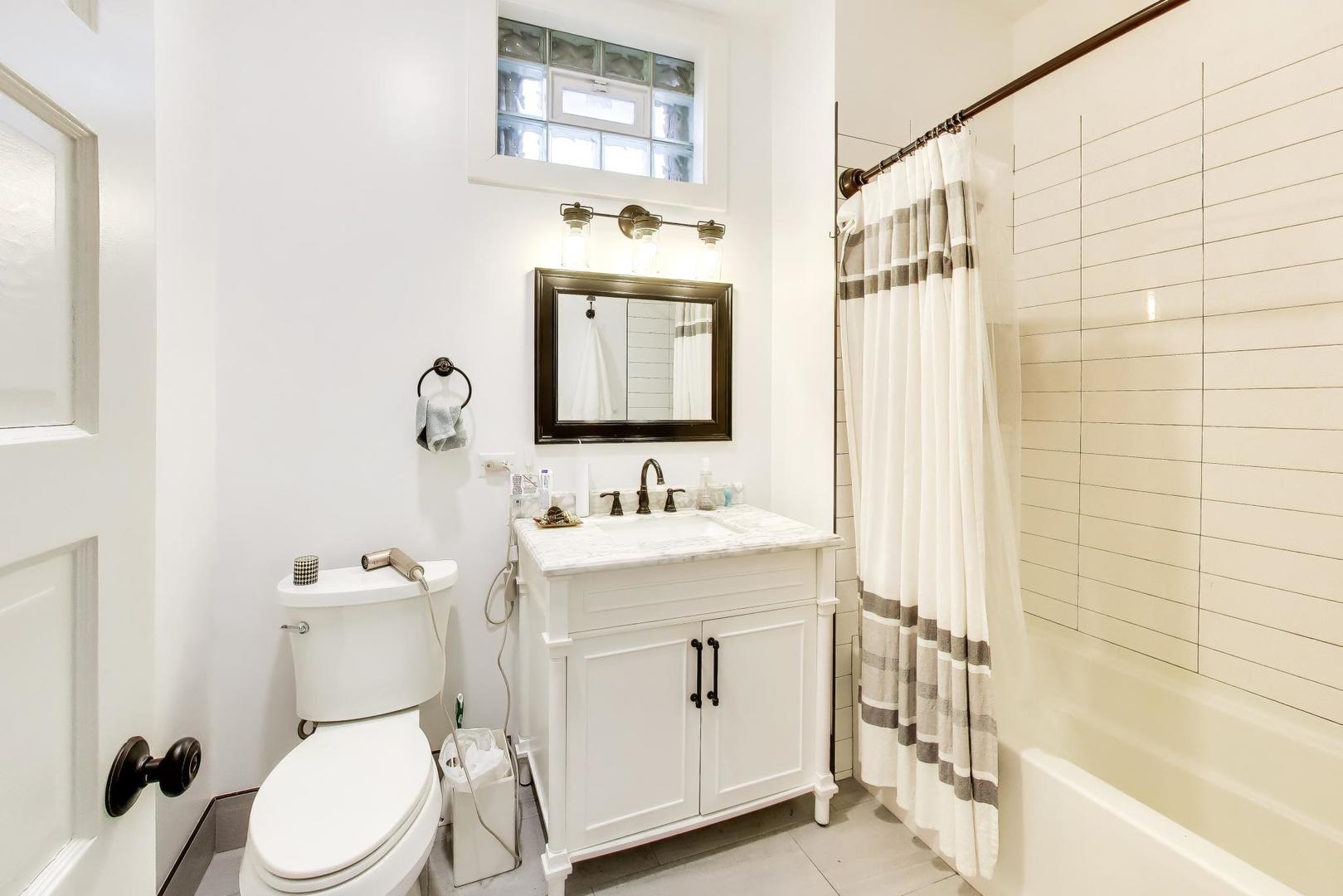 3519 North Seminary Avenue Chicago, IL 60657 - Photo 6 of 43 a bathroom with a sink a toilet and shower