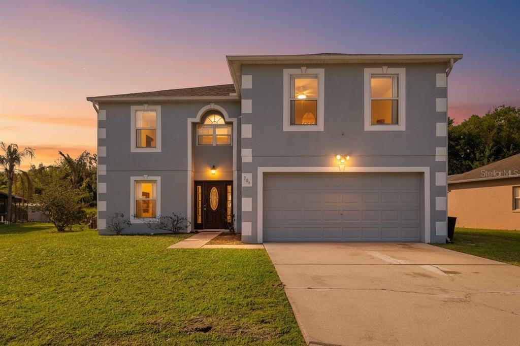 206 Taranto Way Kissimmee, FL 34758 - Photo 1 of 45 a front view of a house with a yard