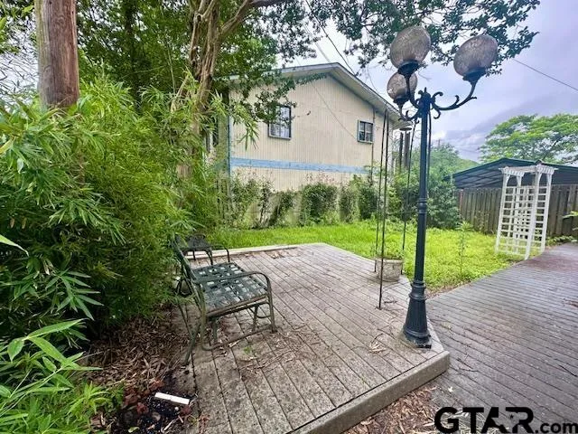 a front view of a house with a yard and fence