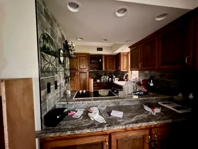 a kitchen with sink refrigerator and cabinets