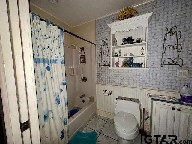 a bathroom with a shower toilet and sink