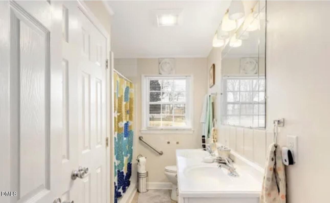 810 Milton Road Durham, NC 27712 - Photo 16 of 21 a bathroom with a sink a mirror and a shower