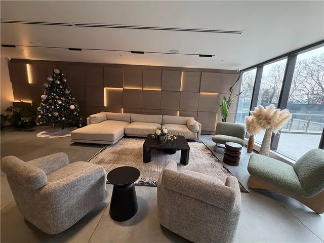 a living room with furniture and potted plants