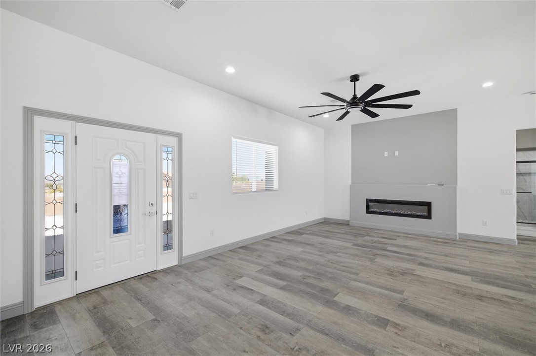 1061 Factory Road Pahrump, NV 89048 - Photo 5 of 41 A spacious living area with sleek flooring and an integrated modern fireplace feature.