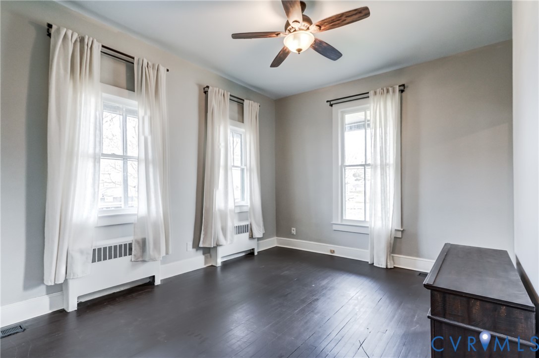 418 4th Street West Point, VA 23181 - Photo 7 of 36 a view of an empty room with wooden floor and a window